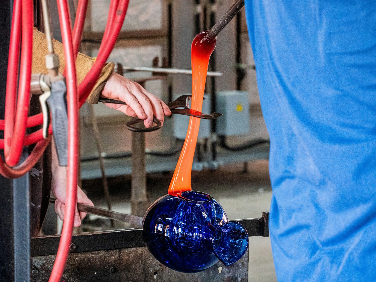 Glass-blowing artisan creating bubble glass at La Verrerie de Biot studio